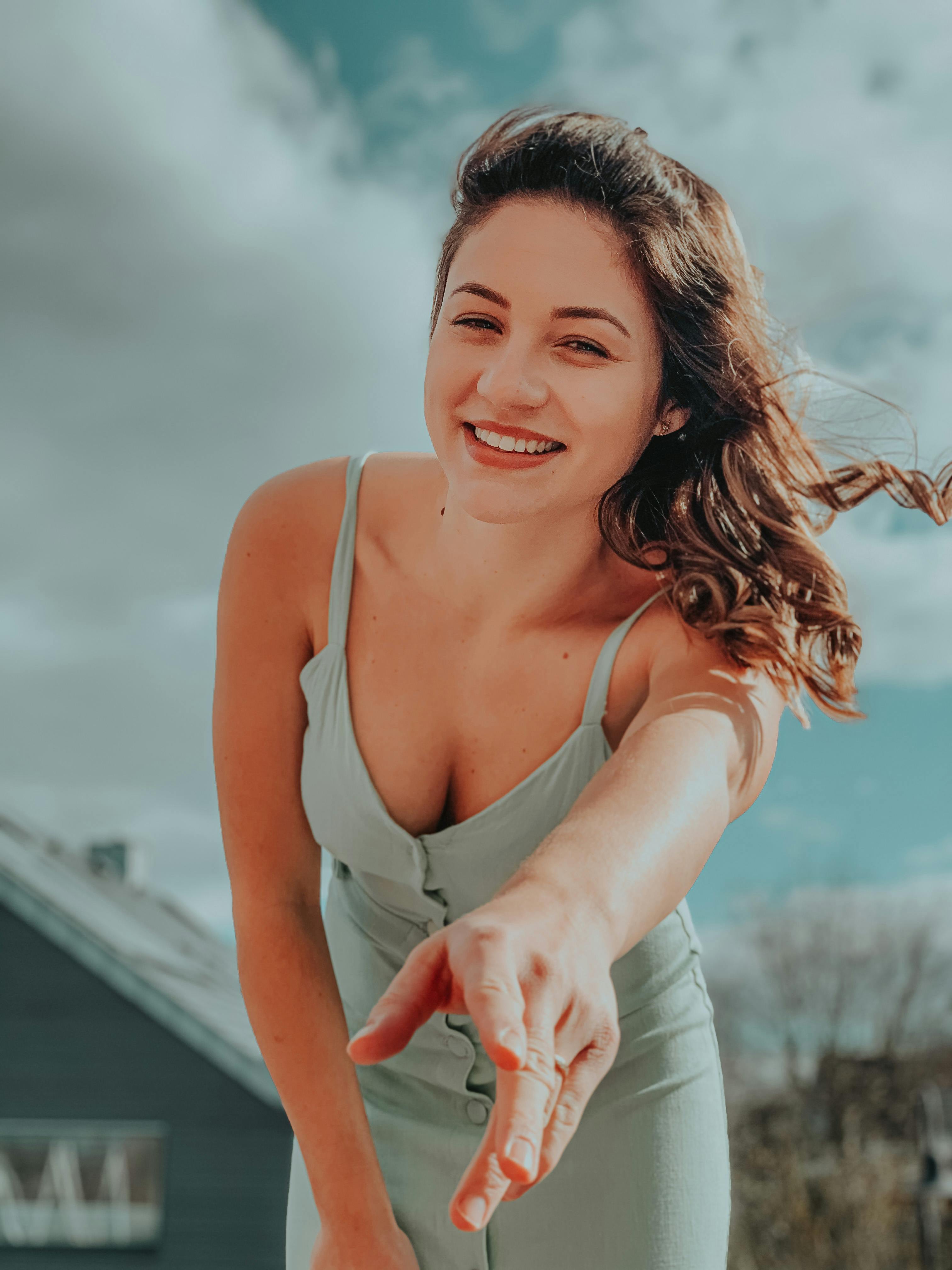 Woman reaching out with joy — building toward financial freedom